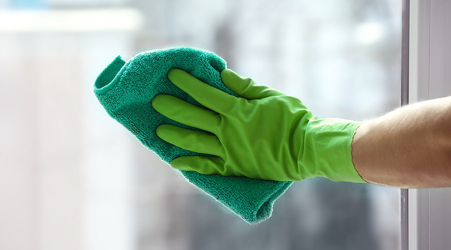 hand with green glove wiping window burnsville mn