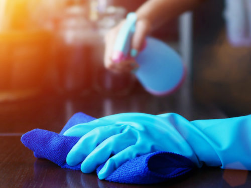 person wearing blue glove cleaning surface burnsville mn
